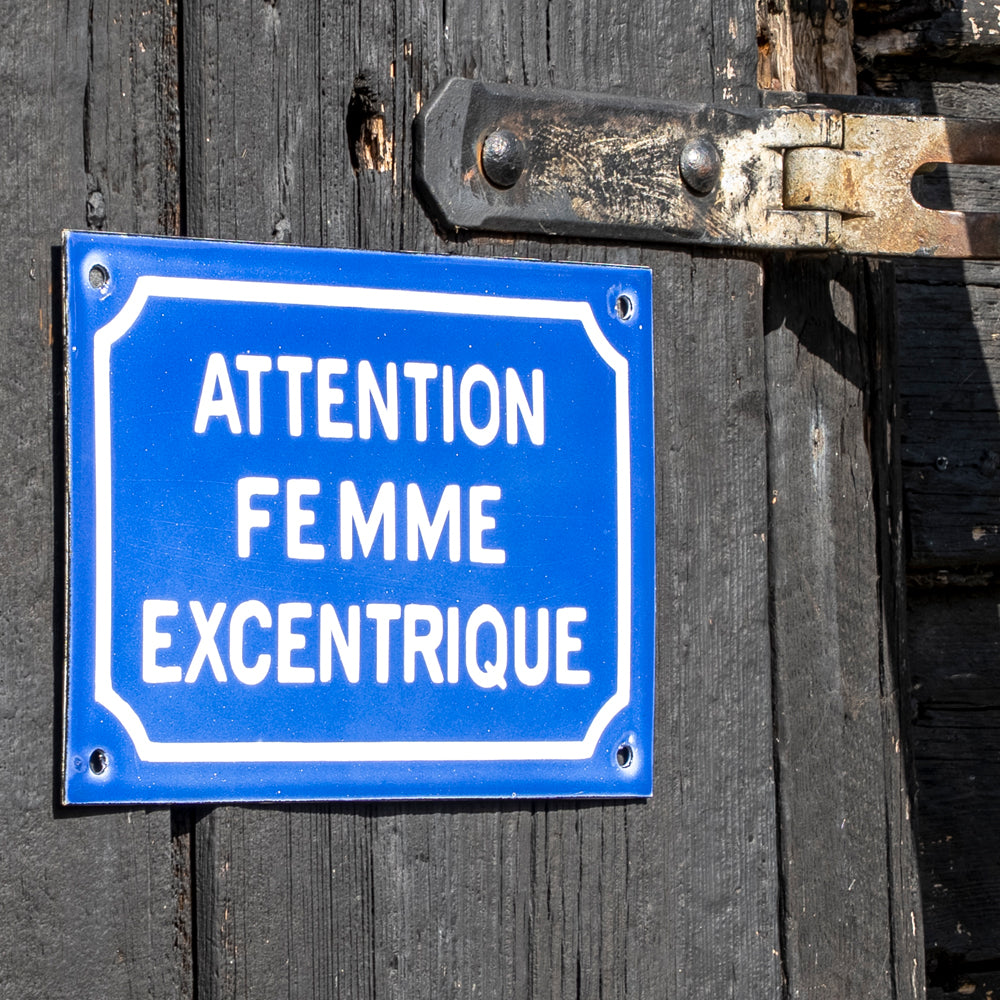 "Attention Femme Excentrique" Comical French Enamel Sign.
