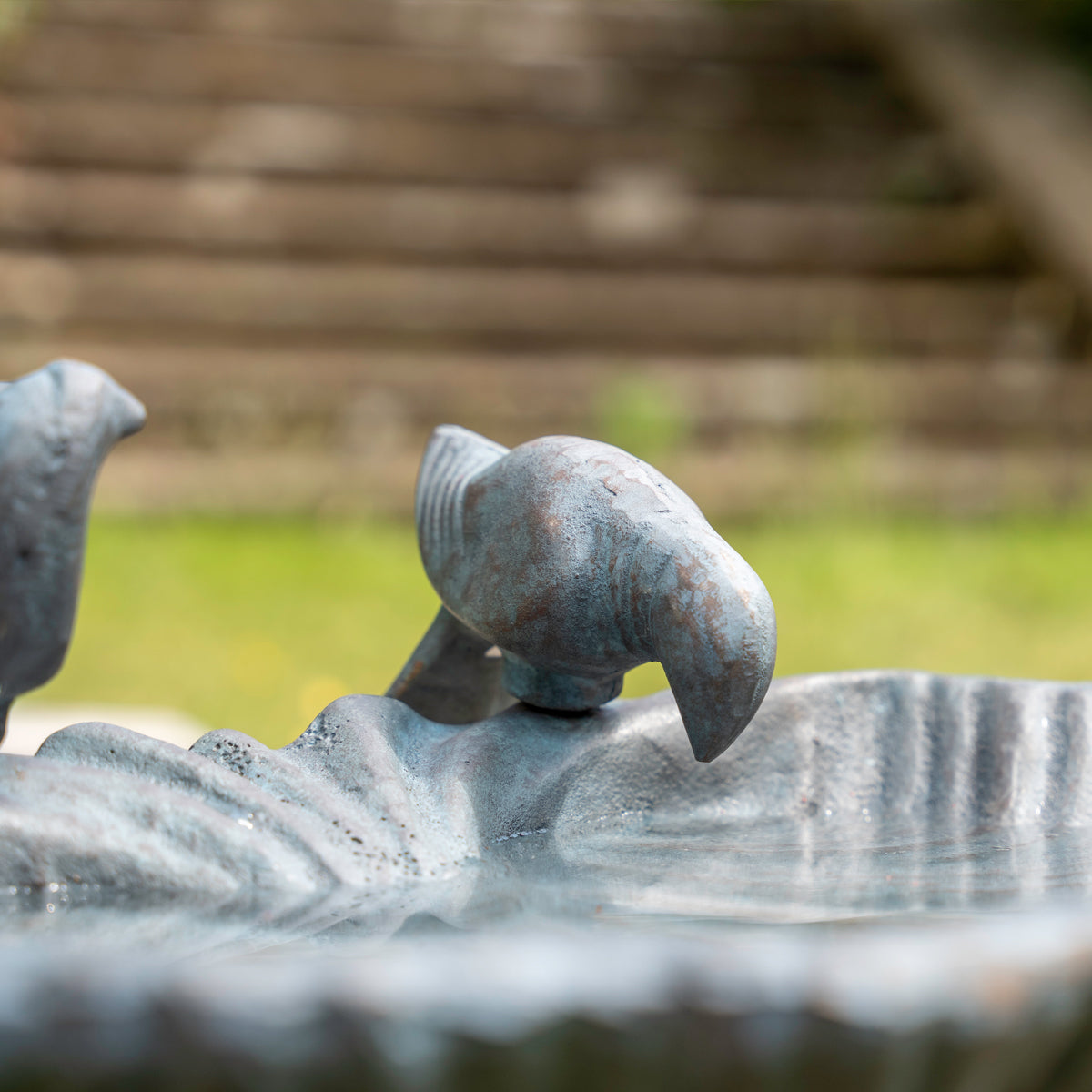 Decorative Iron sculpture of a bird drinking from bird bath
